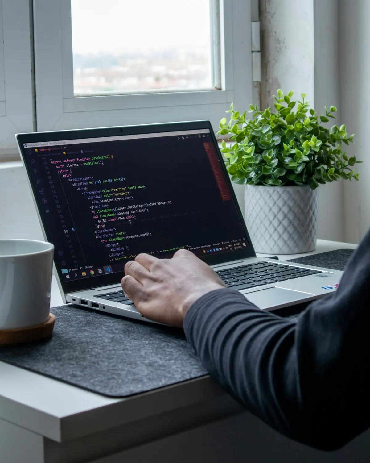 Developer working on a mobile app on a laptop